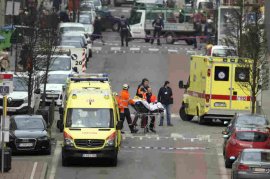 A victim is evacuated on a stretcher by emergency services after an explosion in a metro station in Brussels.