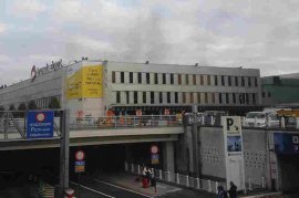 In this image provided by Daniela Schwarzer, smoke is seen at the Brussels airport after explosions were heard Tuesday. More than 30 people are dead and more than 200 wounded after two blasts hit the airport and another struck a metro station in the Belgian capital.